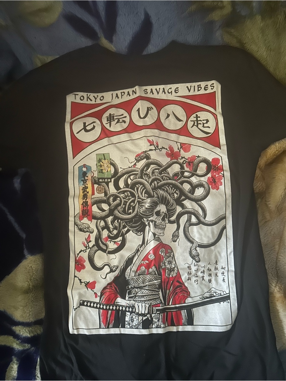 Black Short-Sleeve Men’s Graphic Tee with Red & White Chest Patch